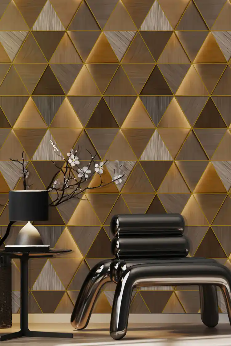 Modern room with 3D gold triangle wallpaper behind sleek black chair and ceramic vase with flowers