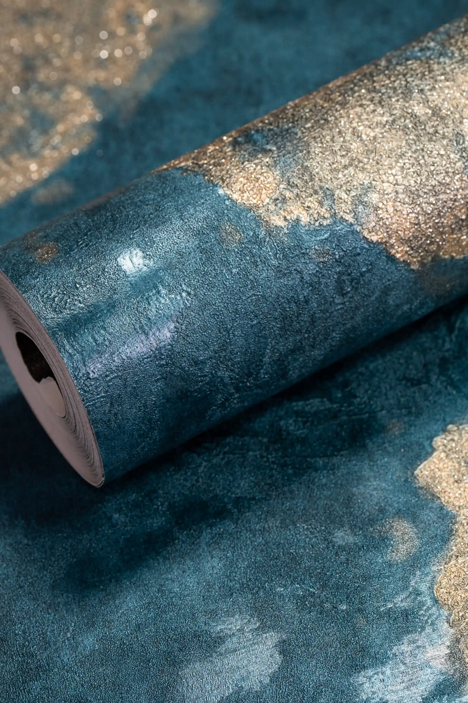 Teal blue wallpaper roll with golden wood slice circular patterns and luxurious shimmer finish
