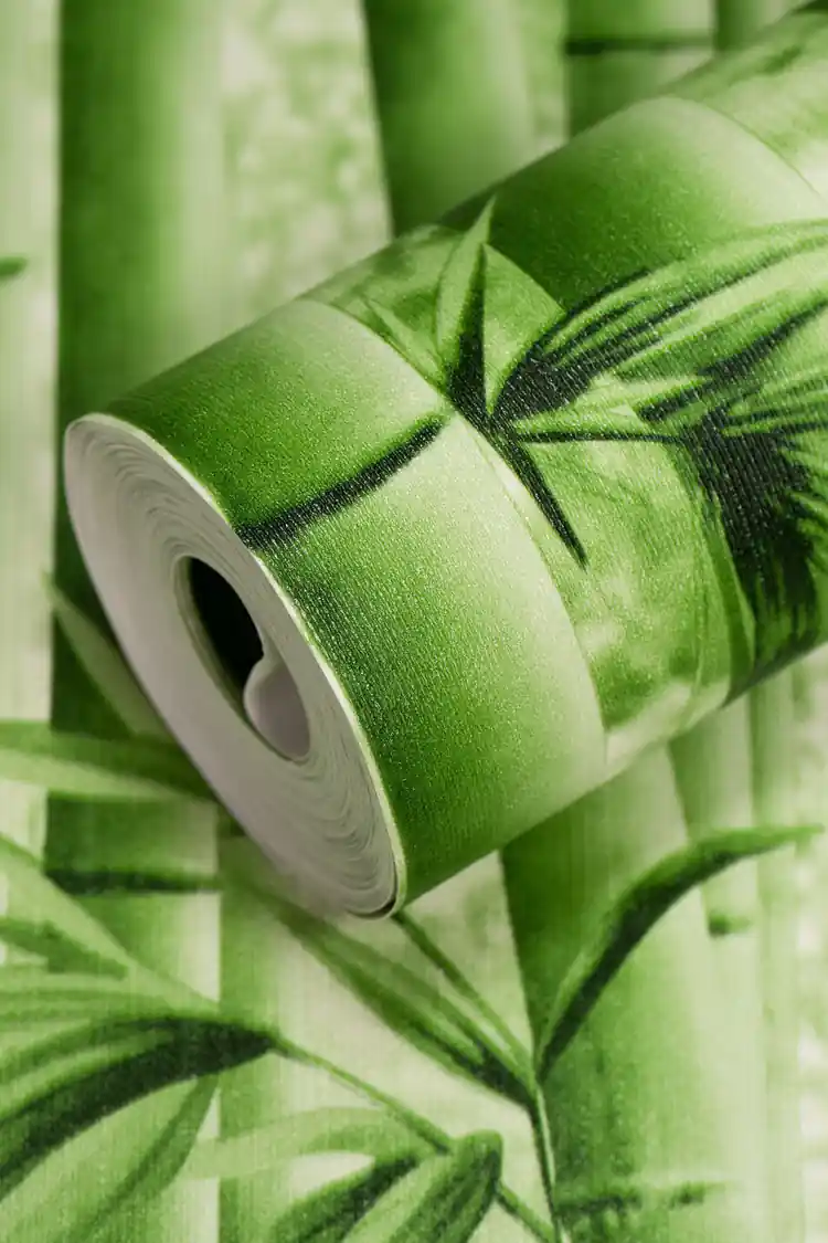 Close-up of a rolled green bamboo wallpaper showing bamboo stalks and leaf print detail