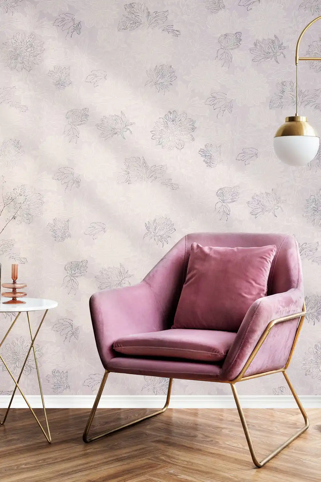 Installed pink chrysanthemum wallpaper in a living space with a blush velvet armchair and brass pendant lamp