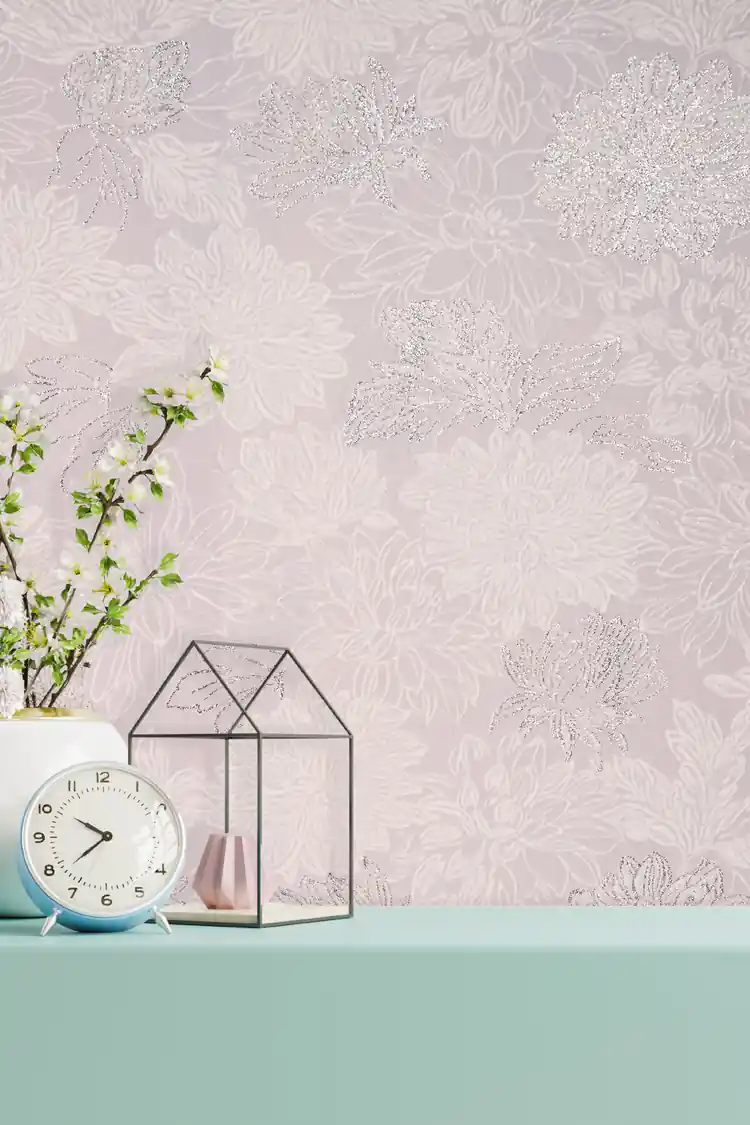 Installed blush floral wallpaper with silver glitter chrysanthemums behind a mint shelf with clock and decor