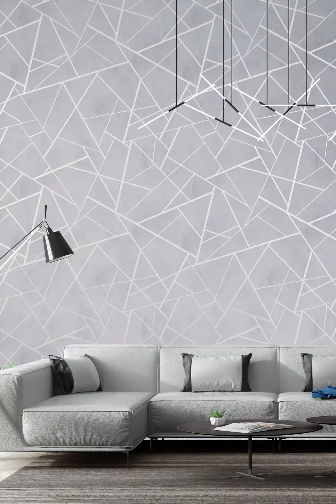 Modern living room with gray geometric wallpaper featuring silver lines behind a minimalist sofa and pendant lights