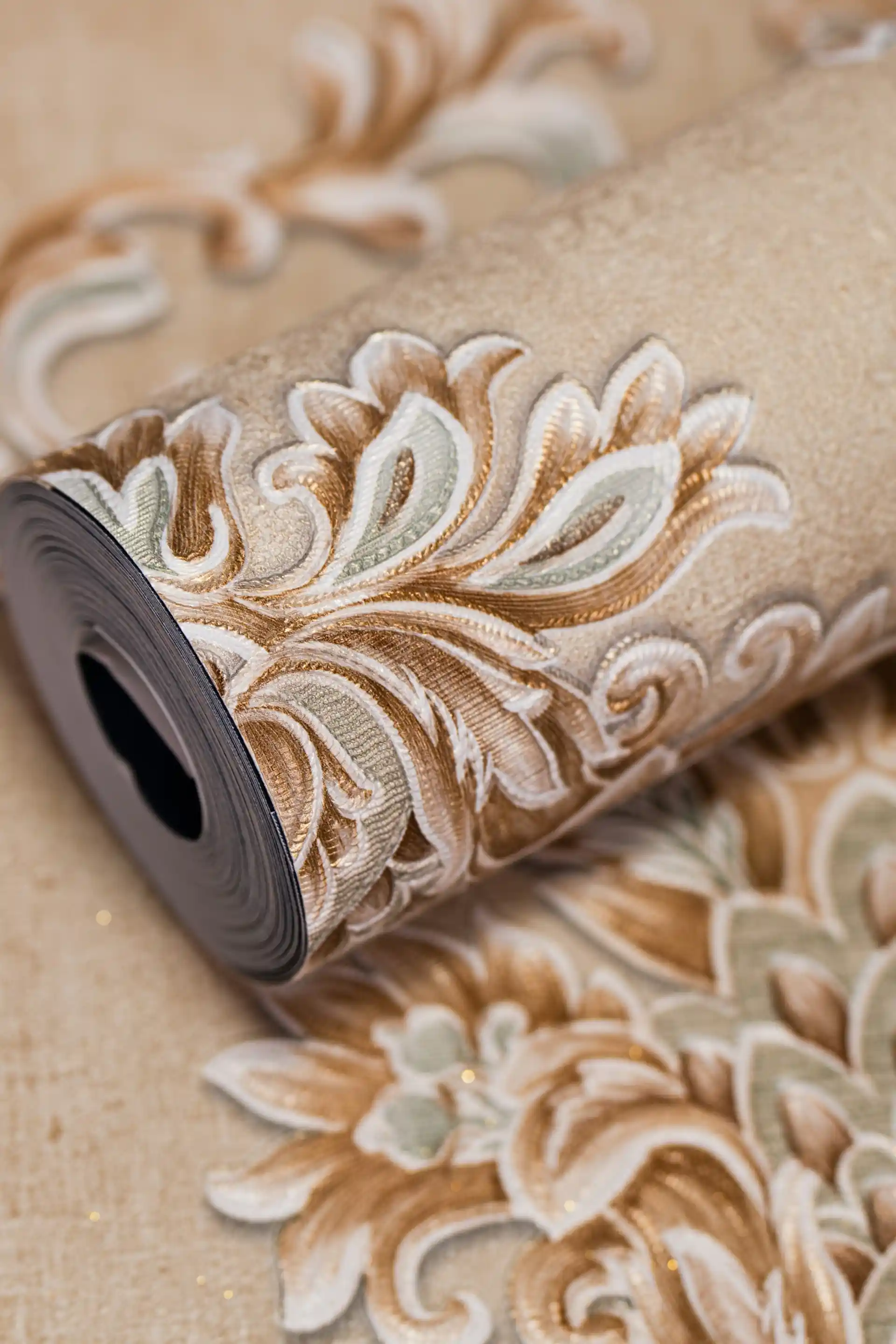 Beige embossed damask wallpaper roll showing ornate classic scroll pattern with copper brown and sage green accents