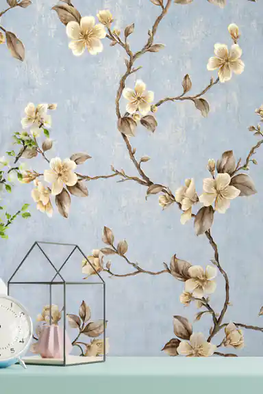 Installed blue floral wallpaper with gold blossoms behind a mint shelf with clock, terrarium, and flowers
