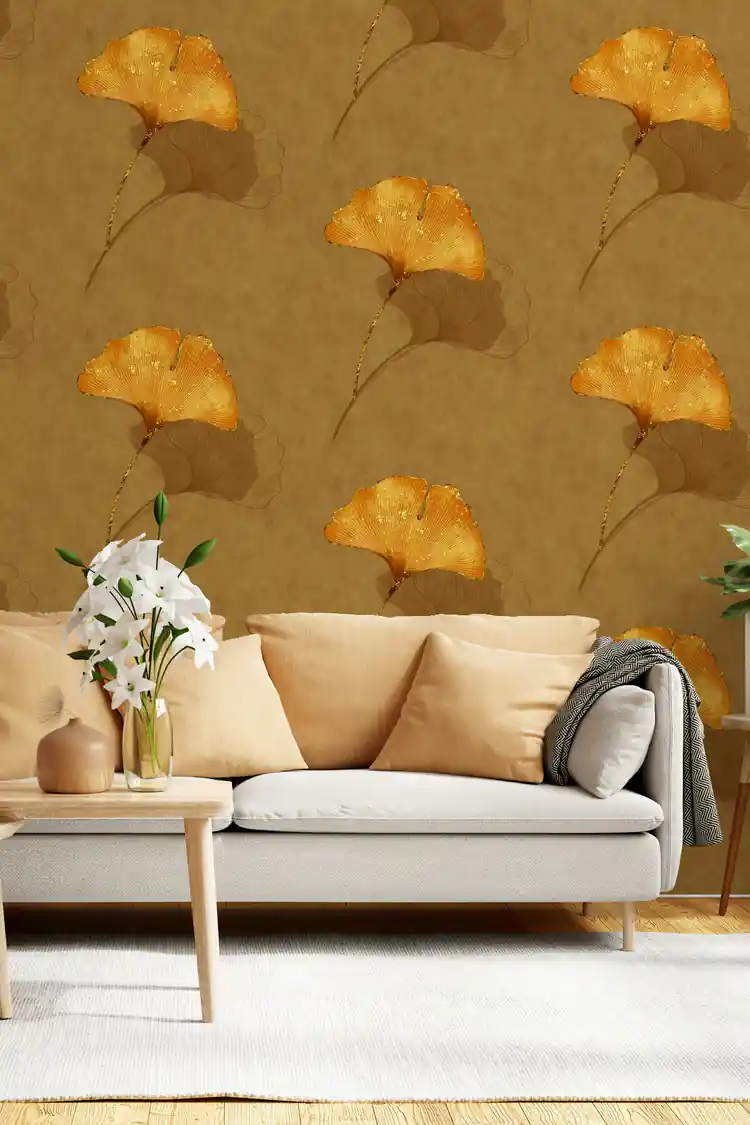 Close-up of warm gold ginkgo leaf wallpaper roll showing embossed golden fan-shaped leaves on rich brown textured background