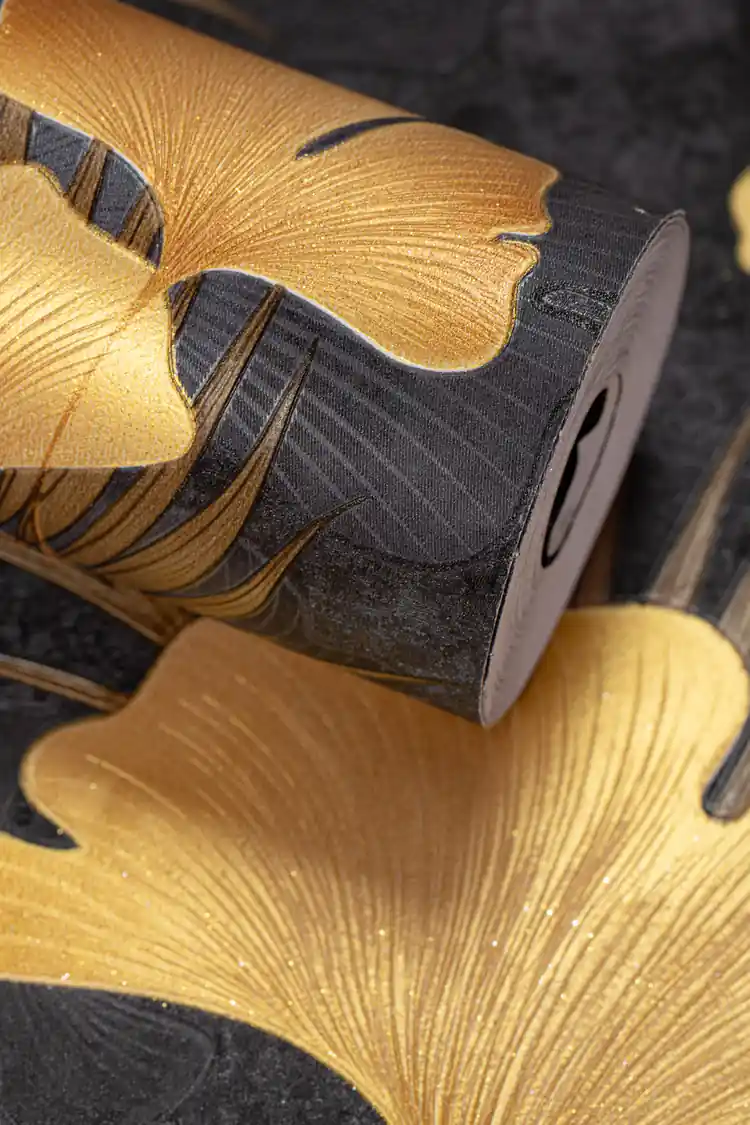 Bold golden ginkgo leaf wallpaper roll with large metallic leaves on a dramatic black textured background