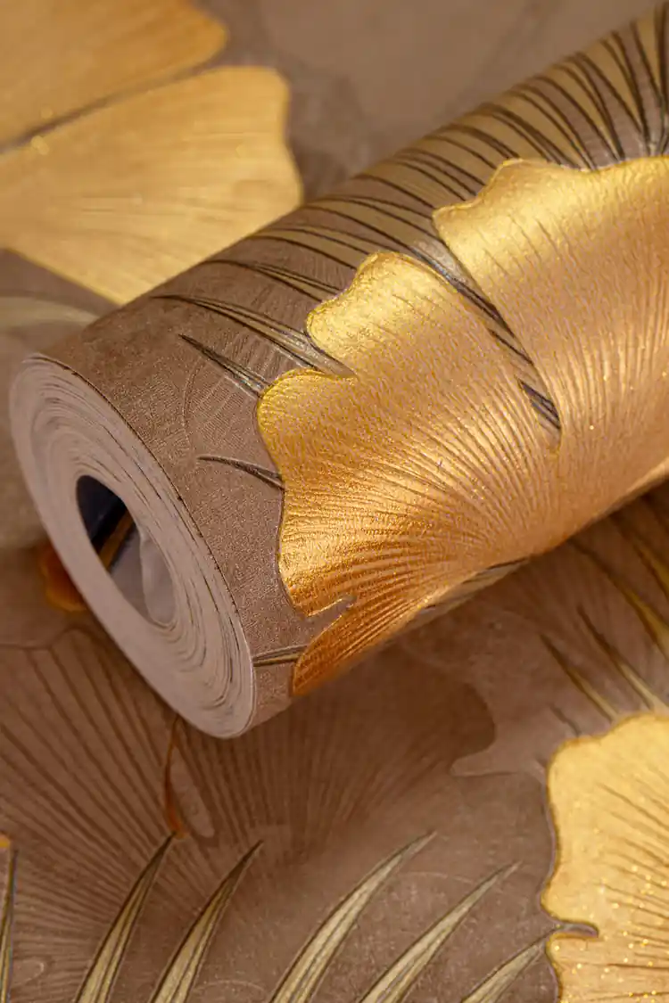 Brown wallpaper with textured golden embossed ginkgo leaves and glitter stems on a warm brown base