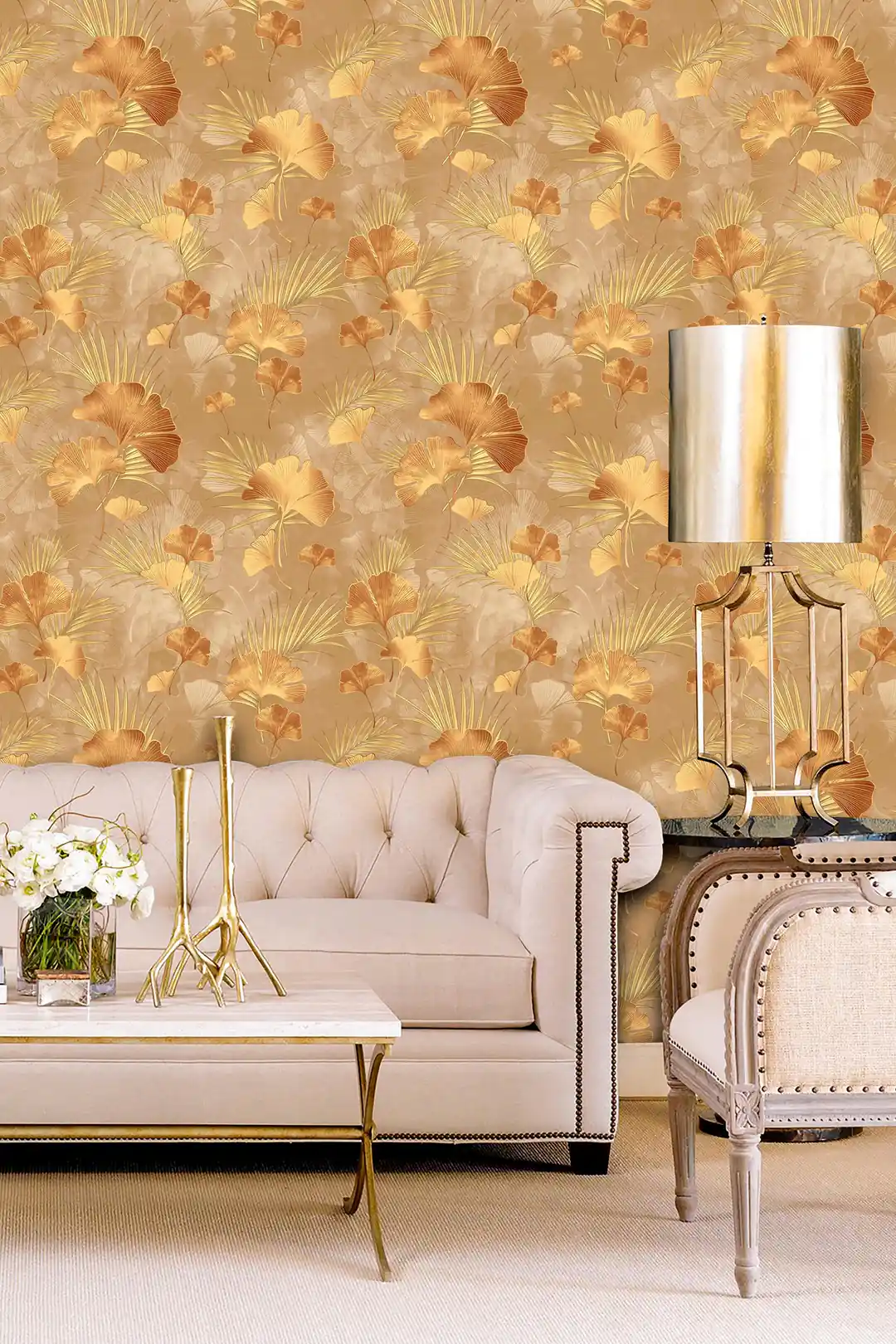 Luxury living room with brown and gold ginkgo wallpaper behind console tables with matching table lamps and decor
