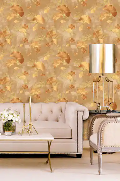 Luxury living room with brown and gold ginkgo wallpaper behind console tables with matching table lamps and decor