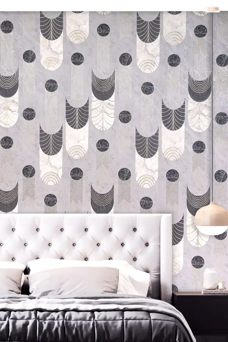 Bedroom with grey art deco wallpaper behind a tufted white headboard with pendant lamp and grey bedding