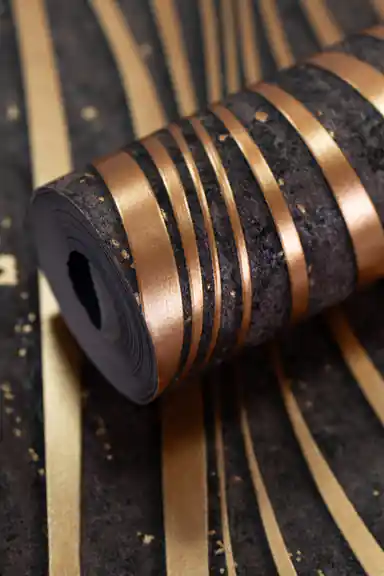 Black wallpaper roll with 3D gold wave stripes and metallic copper shimmer on a dark textured background