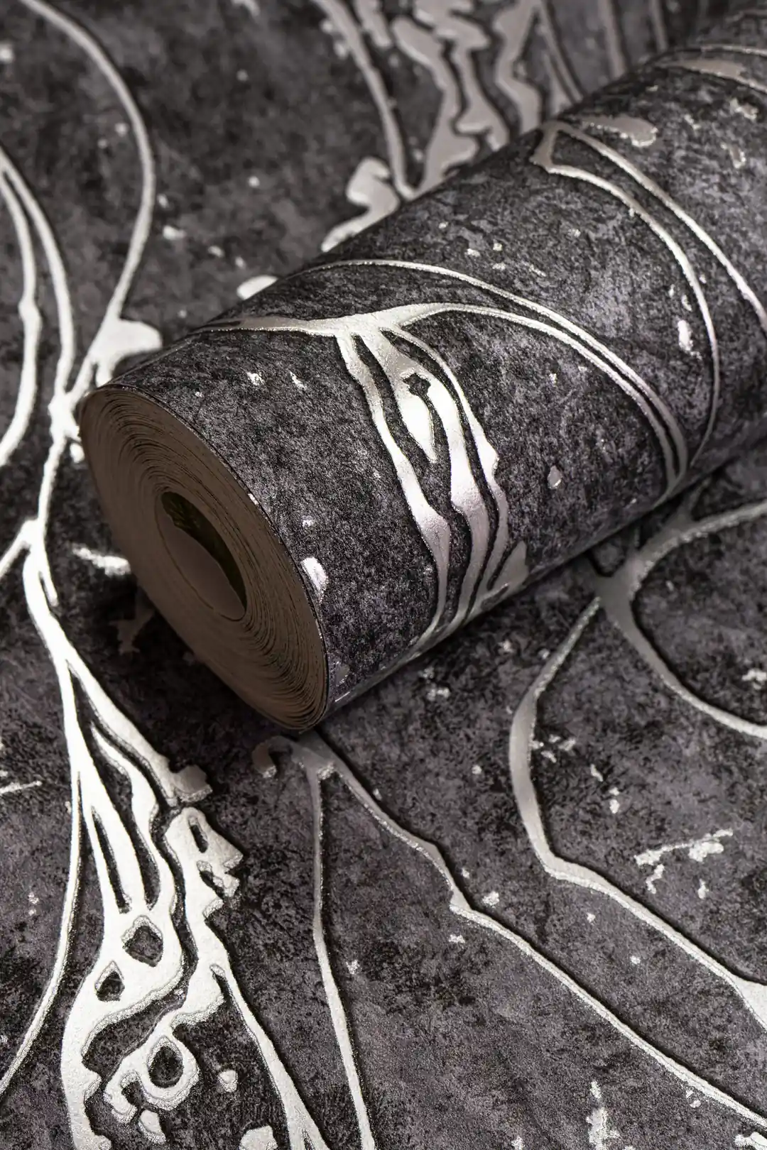 Dark grey abstract wallpaper roll with silver metallic swirling lines on a textured charcoal background
