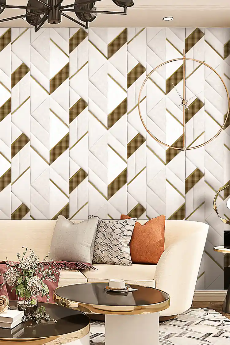 Modern living room with white geometric wallpaper behind a cream curved sofa with chandelier and gold clock