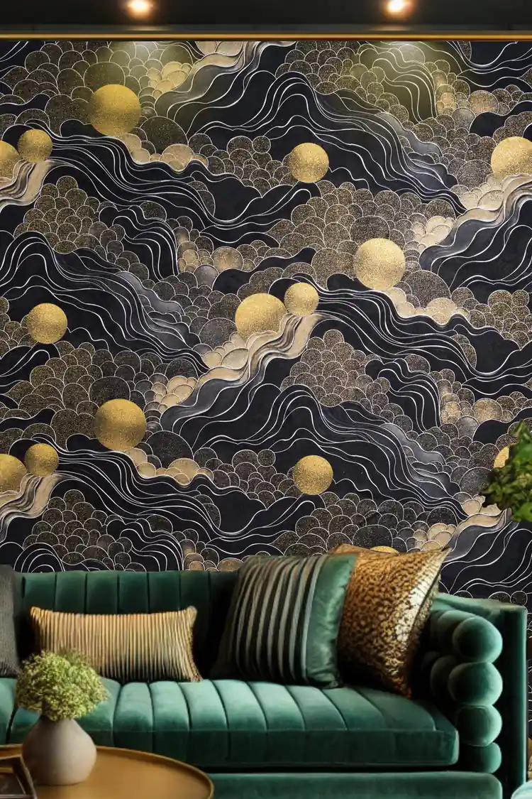 Living room with black cloud and golden sun wallpaper behind a green velvet sofa with gold accent pillows