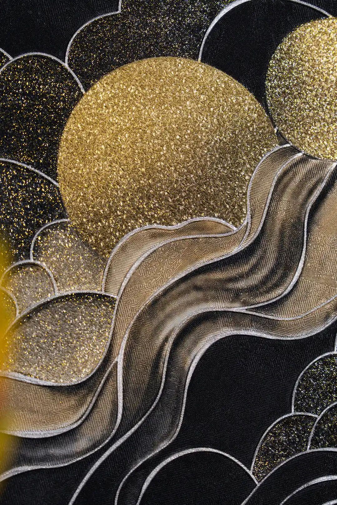 Detailed view of a large gold glitter sun with flowing silver marble waves on black cloud wallpaper
