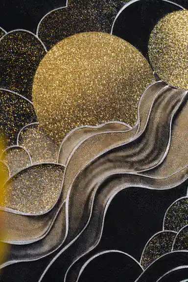 Detailed view of a large gold glitter sun with flowing silver marble waves on black cloud wallpaper