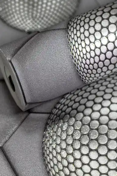 Rolled grey 3D hexagon wallpaper with textured metallic spheres covered in dotted pattern