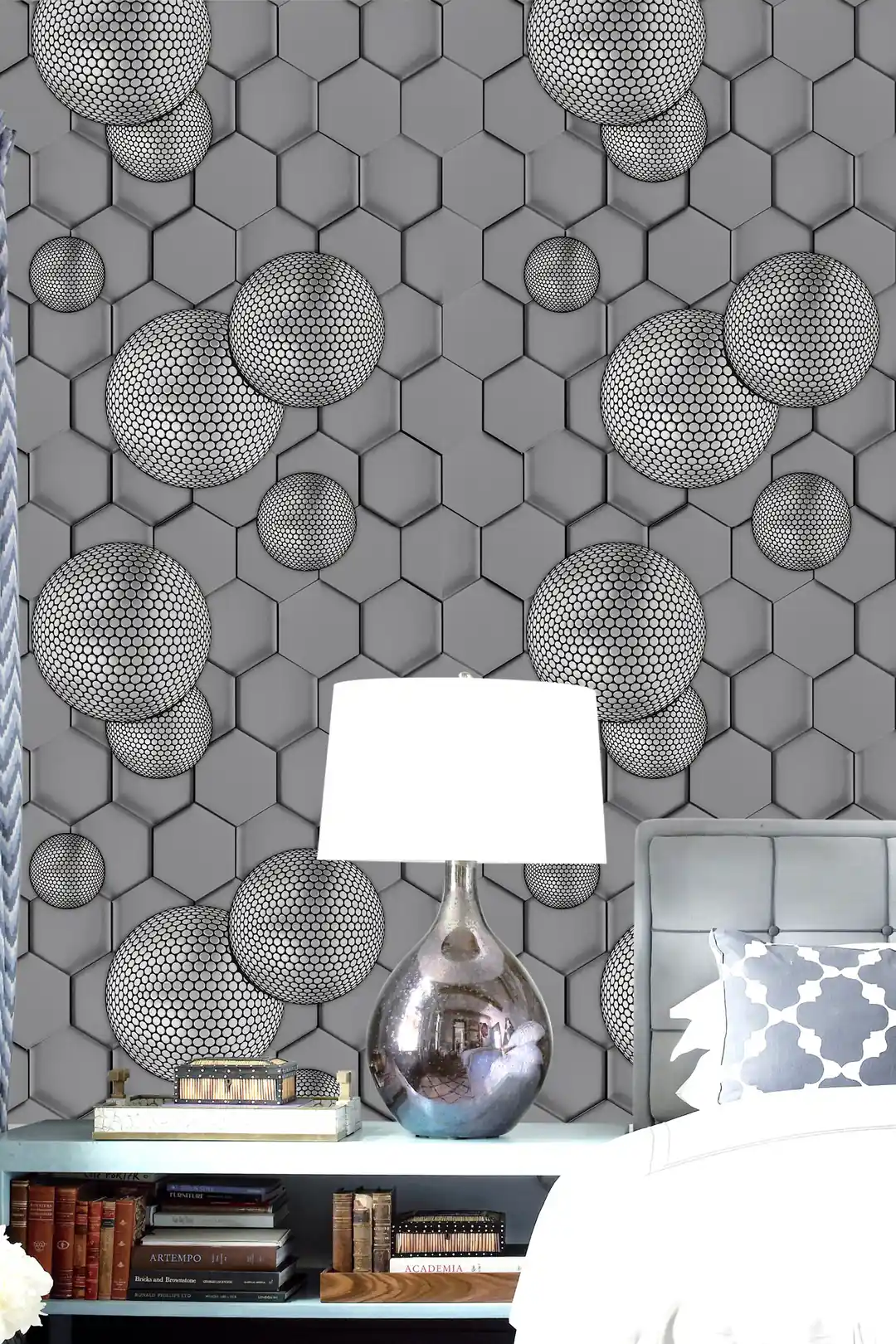 Grey geometric hexagon wallpaper installed in a room with textured 3D spheres beside a white lamp and silver vase