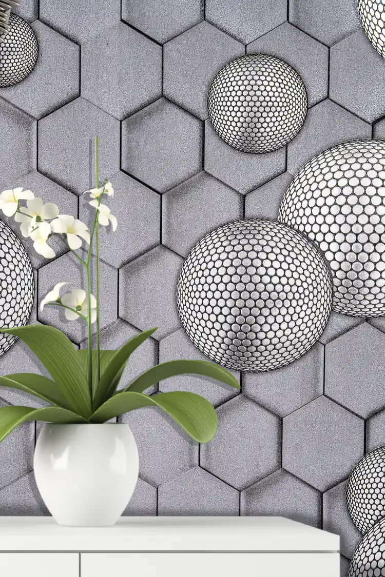 Installed wall view of grey hexagonal wallpaper with dotted spheres next to a white orchid on a shelf