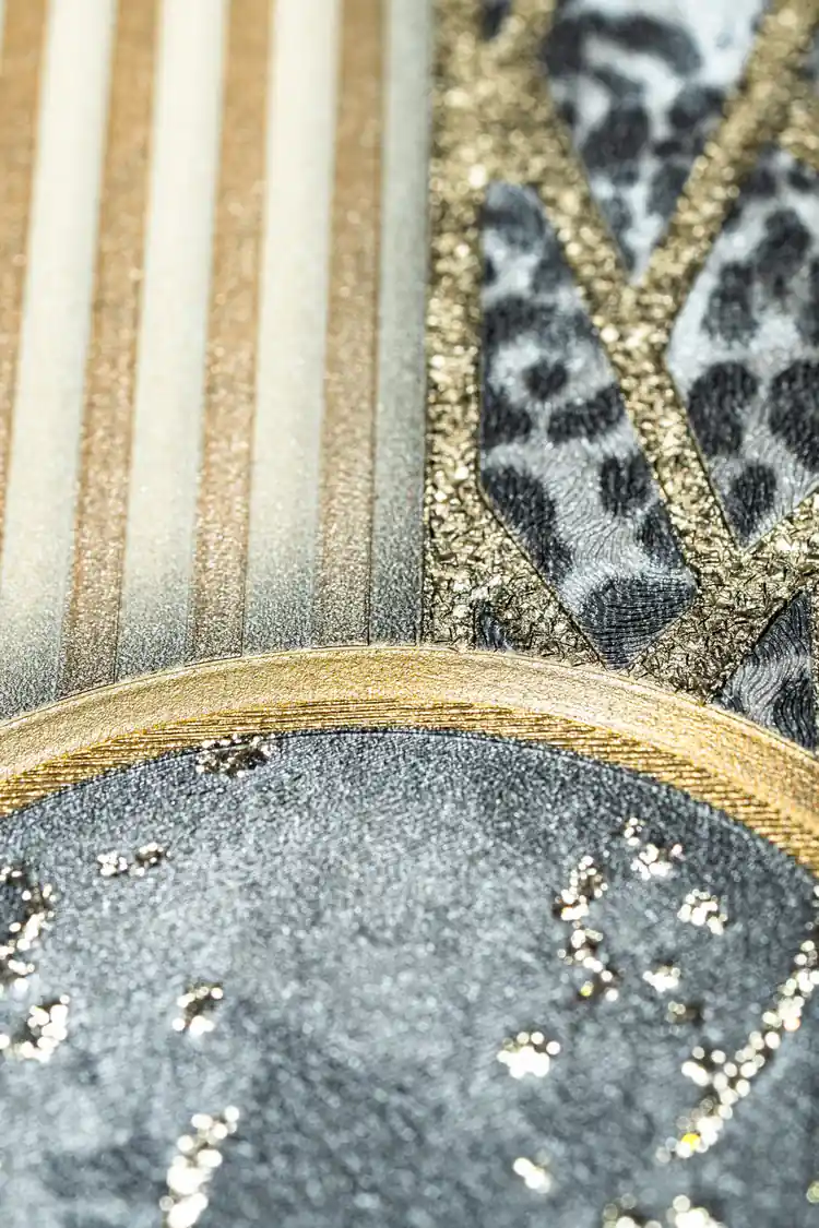 Extreme close-up of cream striped texture meeting leopard print band with gold-rimmed marble circle detail