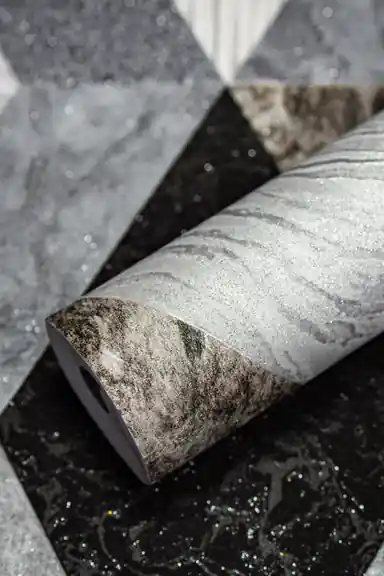 Rolled grey and black geometric diamond marble tiles wallpaper with silver shimmer on textured surface