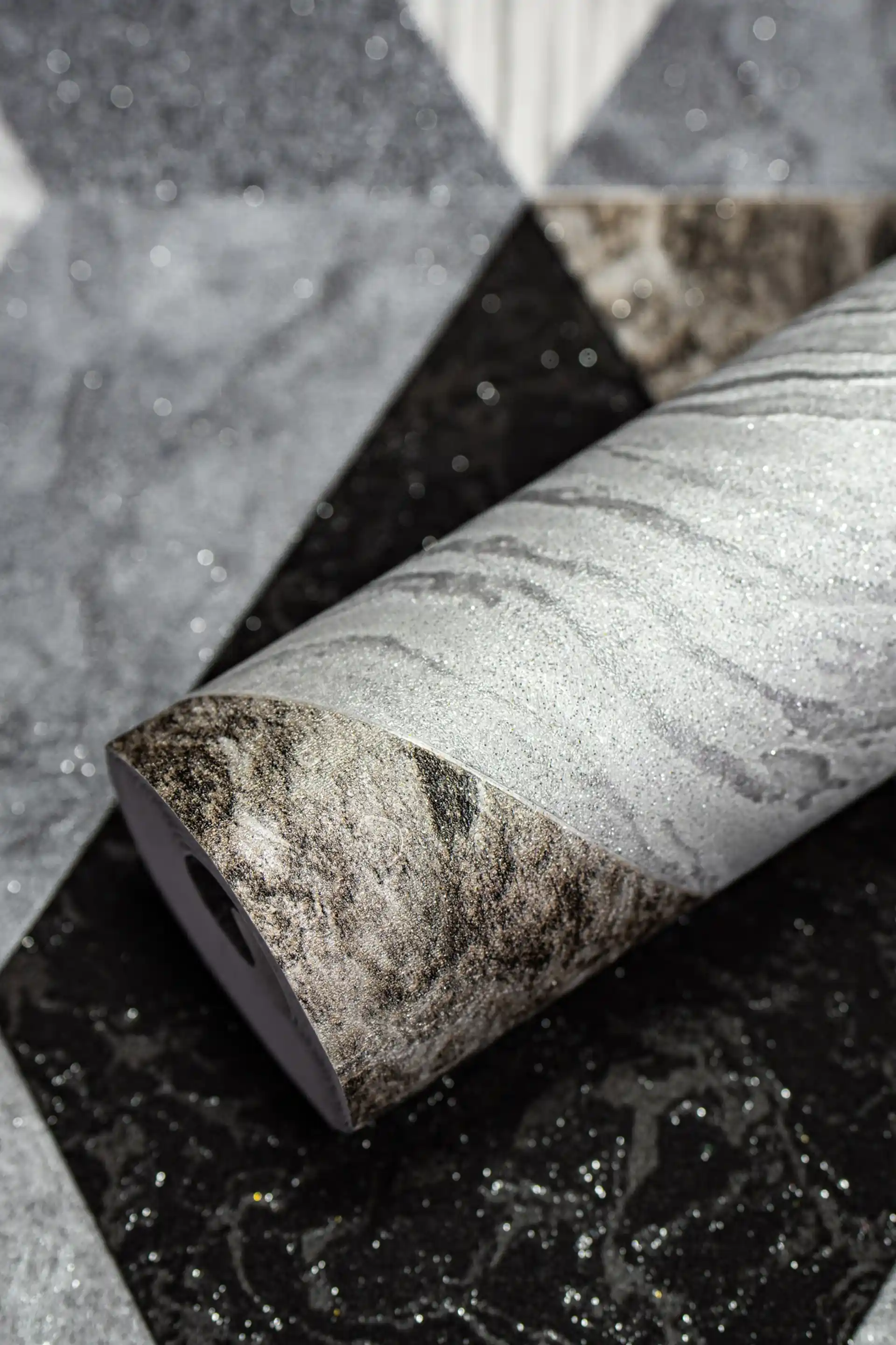 Rolled grey and black geometric diamond marble tiles wallpaper with silver shimmer on textured surface