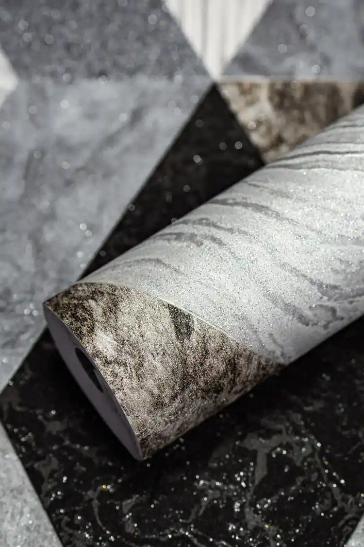 Rolled grey and black geometric diamond marble tiles wallpaper with silver shimmer on textured surface