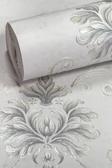 Rolled silver damask floral pattern wallpaper with embossed metallic scrollwork on light grey base