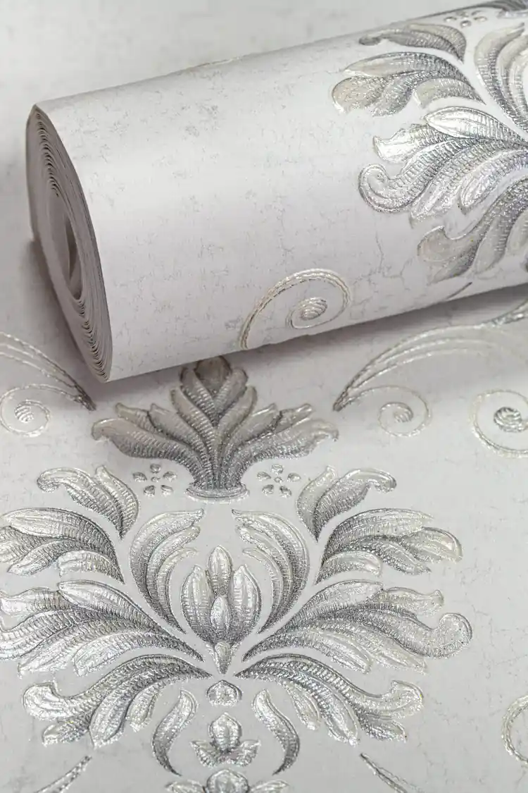 Rolled silver damask floral pattern wallpaper with embossed metallic scrollwork on light grey base