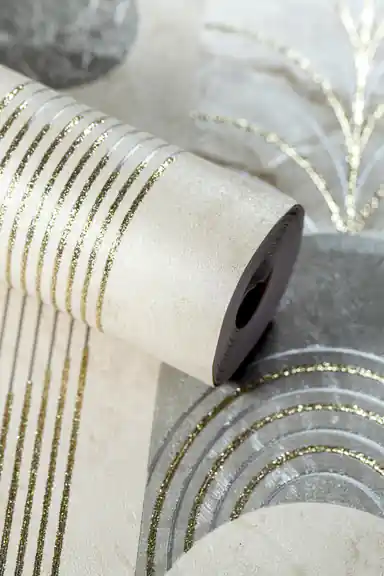 Rolled beige deco wallpaper with grey geometric arches, sunburst fan shapes, and gold glitter line accents on textured base