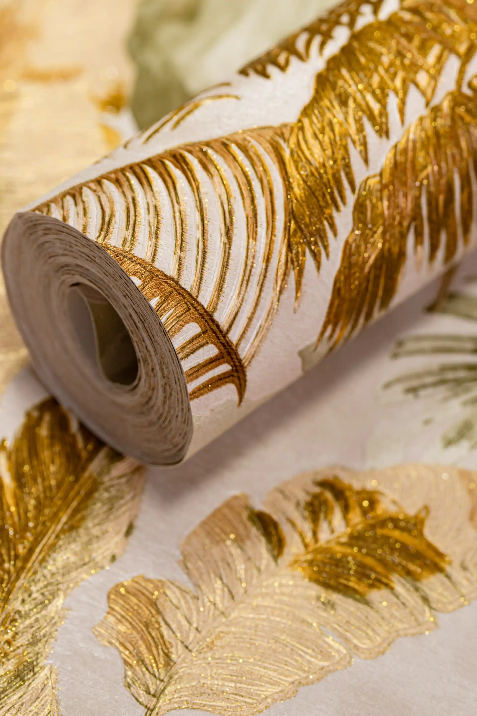 Rolled tropical gold palm fronds wallpaper with embossed metallic leaves on white and green base