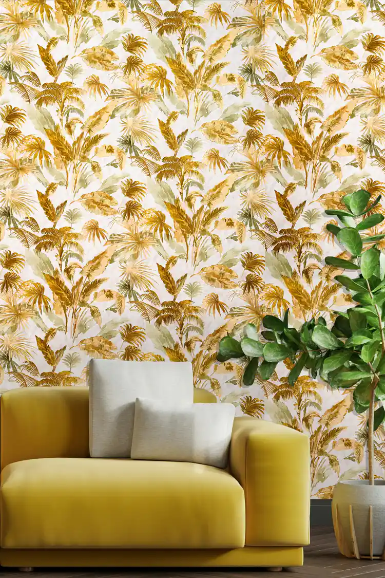 Gold palm fronds wallpaper installed in a living room with yellow armchair and tropical fiddle leaf fig