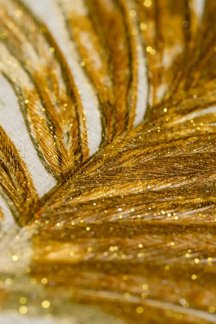 Extreme close-up macro showing embossed golden palm frond texture with glitter sparkle detail on wallpaper