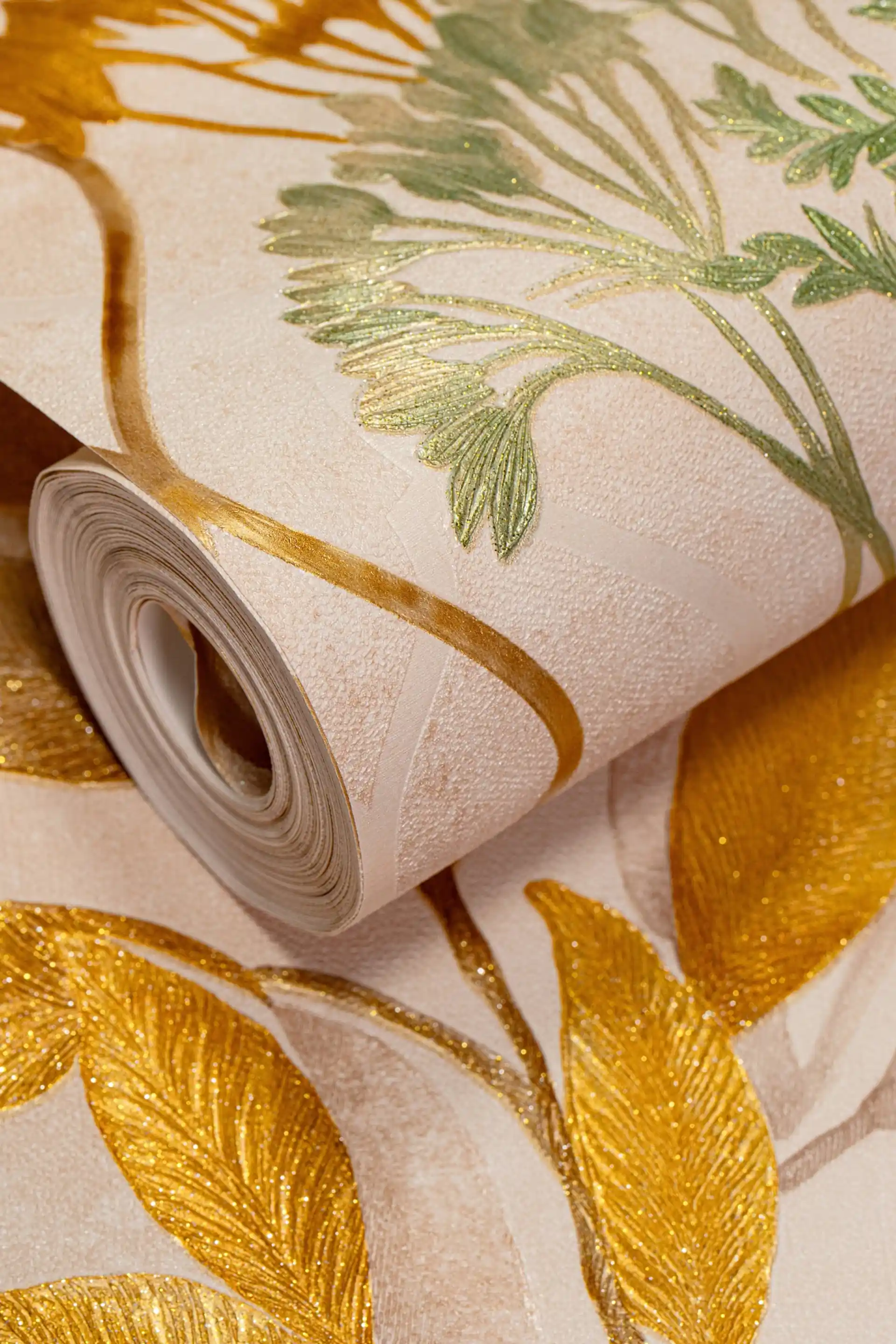 Rolled golden fern trellis wallpaper with embossed gold leaves and green botanical accents on cream base