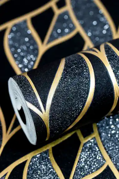 Rolled black and gold leaf pattern wallpaper showing art deco shapes with sparkle glitter texture