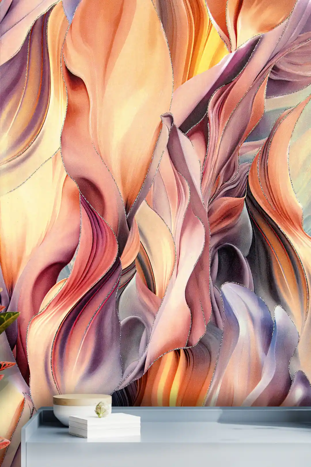 Close-up of flowing warm-toned feather wallpaper installed on wall above a grey shelf with decor