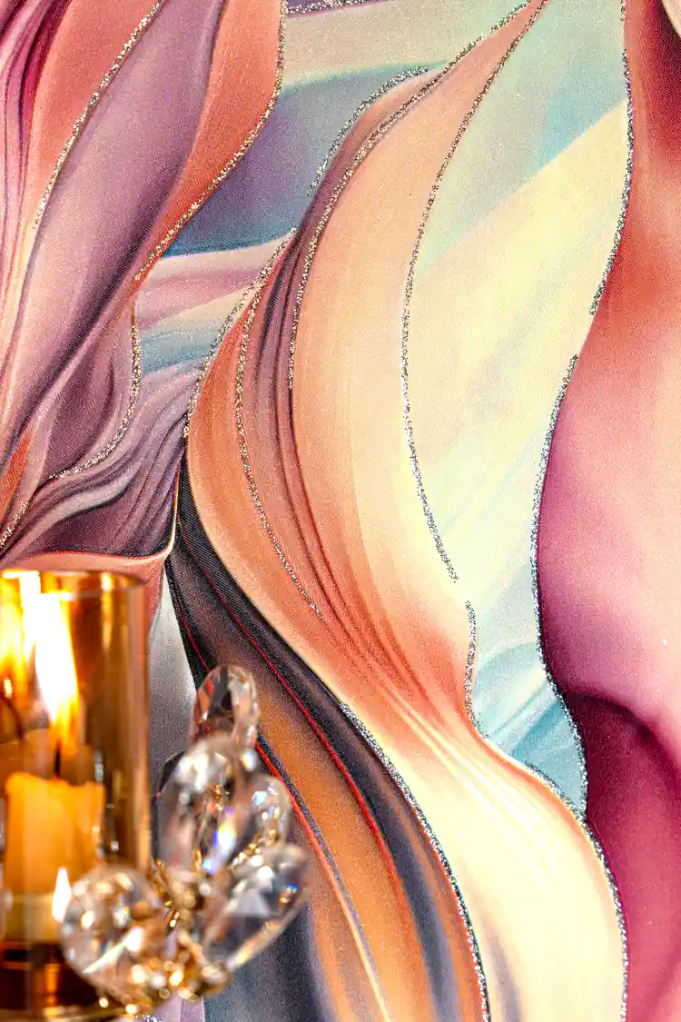 Detail of rainbow feather wallpaper with silver glitter accent line and crystal ornament with candle