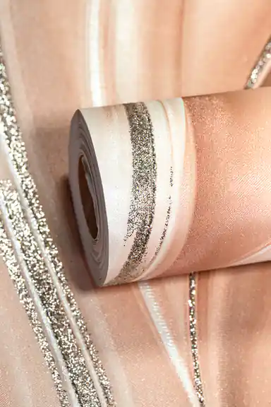 Rolled peach wallpaper with flowing silk wave pattern and silver glitter accent lines on warm base