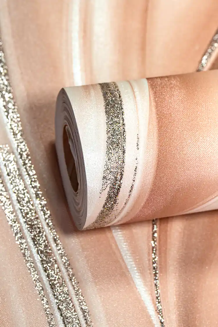 Rolled peach wallpaper with flowing silk wave pattern and silver glitter accent lines on warm base