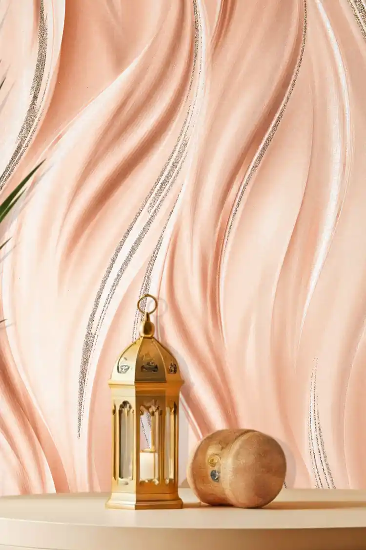 Installed wall view of peach flowing wave wallpaper with a gold lantern and decorative sphere on shelf