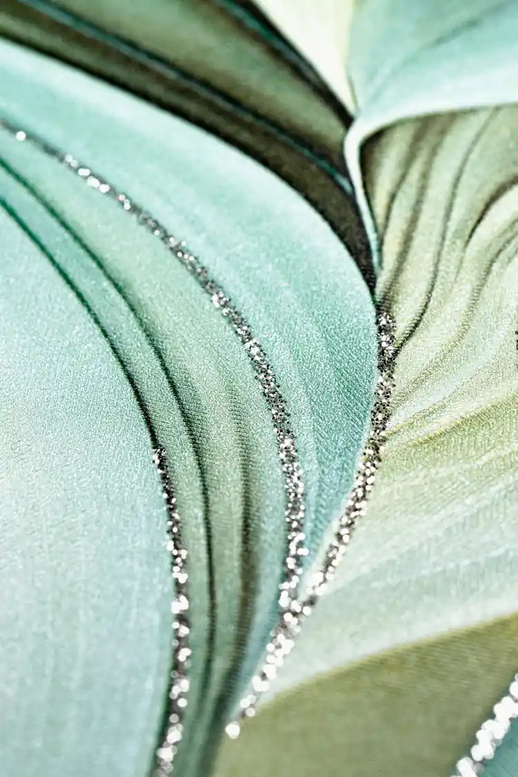 Extreme close-up macro of sage green and olive flowing leaf texture with sparkling glitter line detail