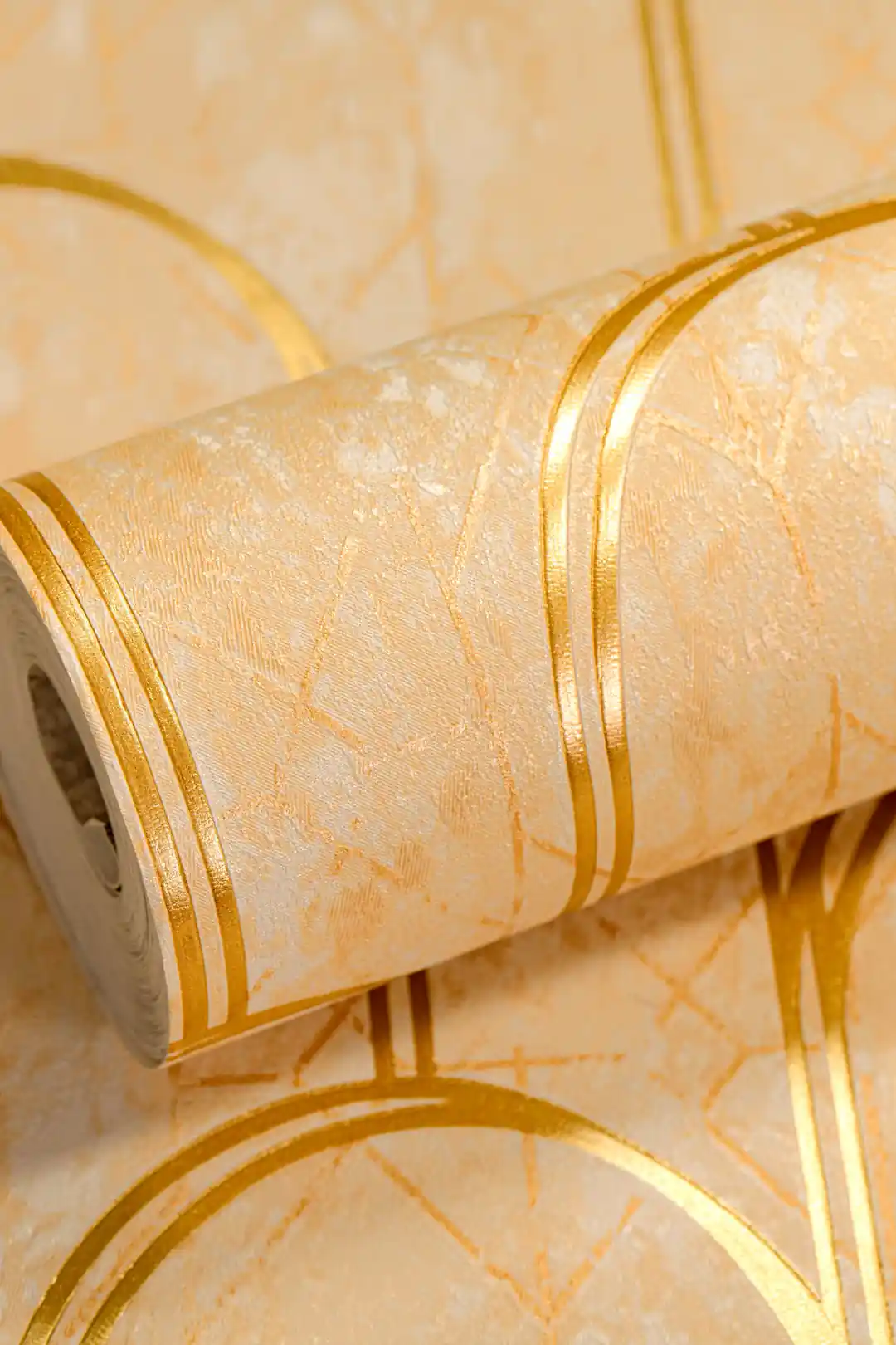 Rolled beige geometric arch wallpaper with gold metallic lines on textured marble-effect cream surface