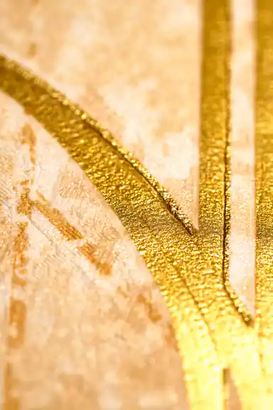 Extreme close-up macro of raised gold metallic line detail on textured gold art deco wallpaper surface
