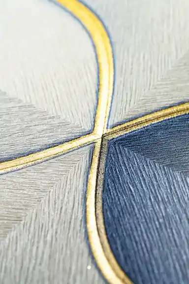 Macro texture detail of gold outline intersecting blue and grey hexagon petal shapes