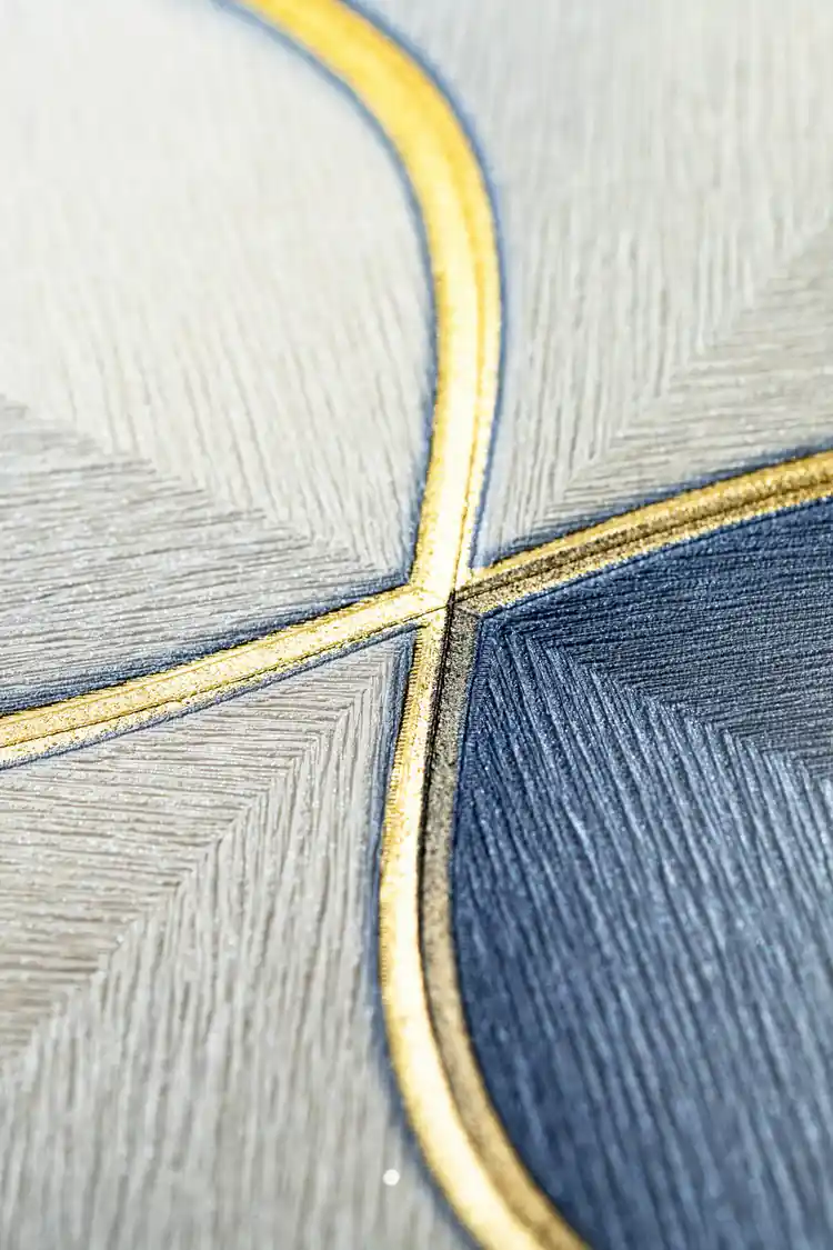 Macro texture detail of gold outline intersecting blue and grey hexagon petal shapes
