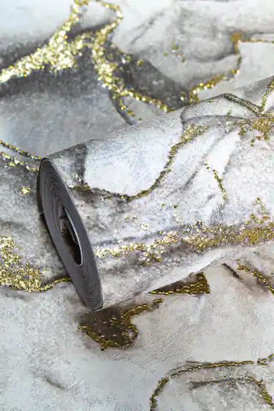 Full roll of grey marble wallpaper with gold glitter veining laid on the unrolled pattern