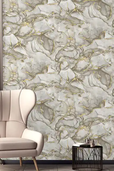 Room scene with grey marble wallpaper behind a beige wingback armchair and black side table