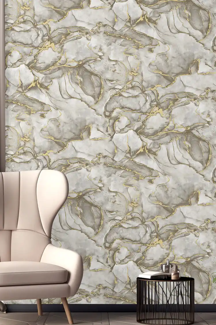 Room scene with grey marble wallpaper behind a beige wingback armchair and black side table