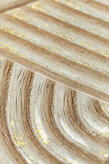 Extreme macro of glitter particles scattered across the curved wood grain texture lines
