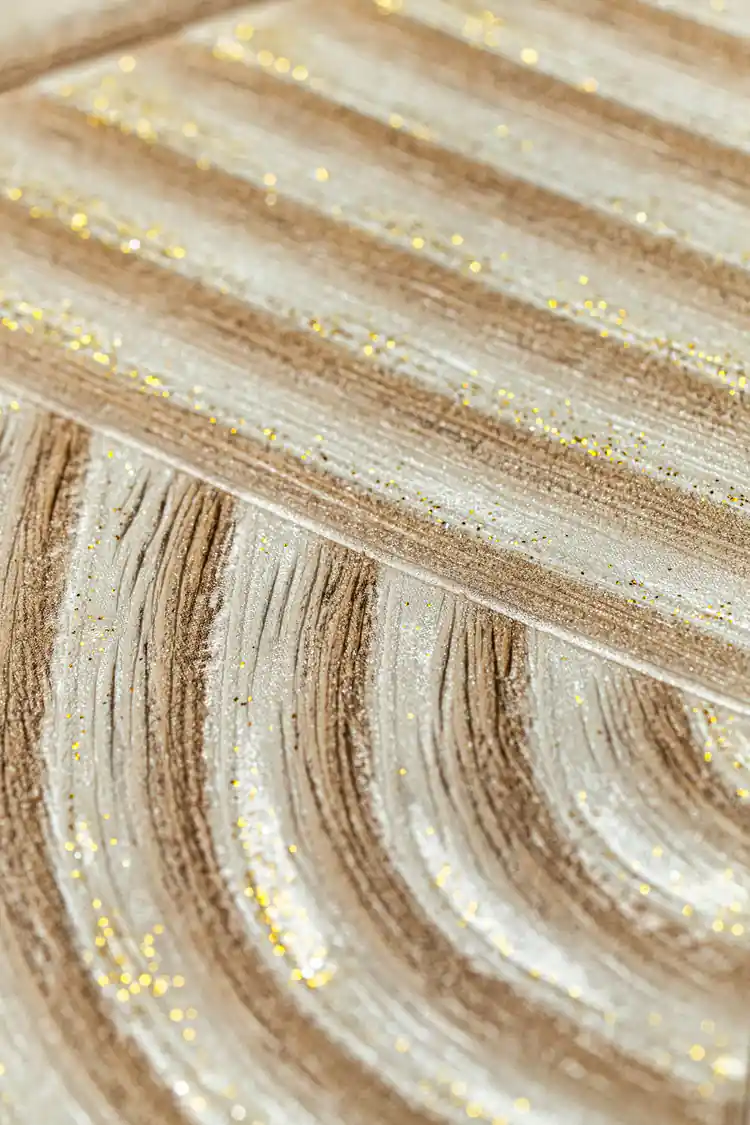 Extreme macro of glitter particles scattered across the curved wood grain texture lines
